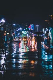 小蓝视频网站推荐的都市悬疑剧封面，主角在雨夜街头独行的孤独画面